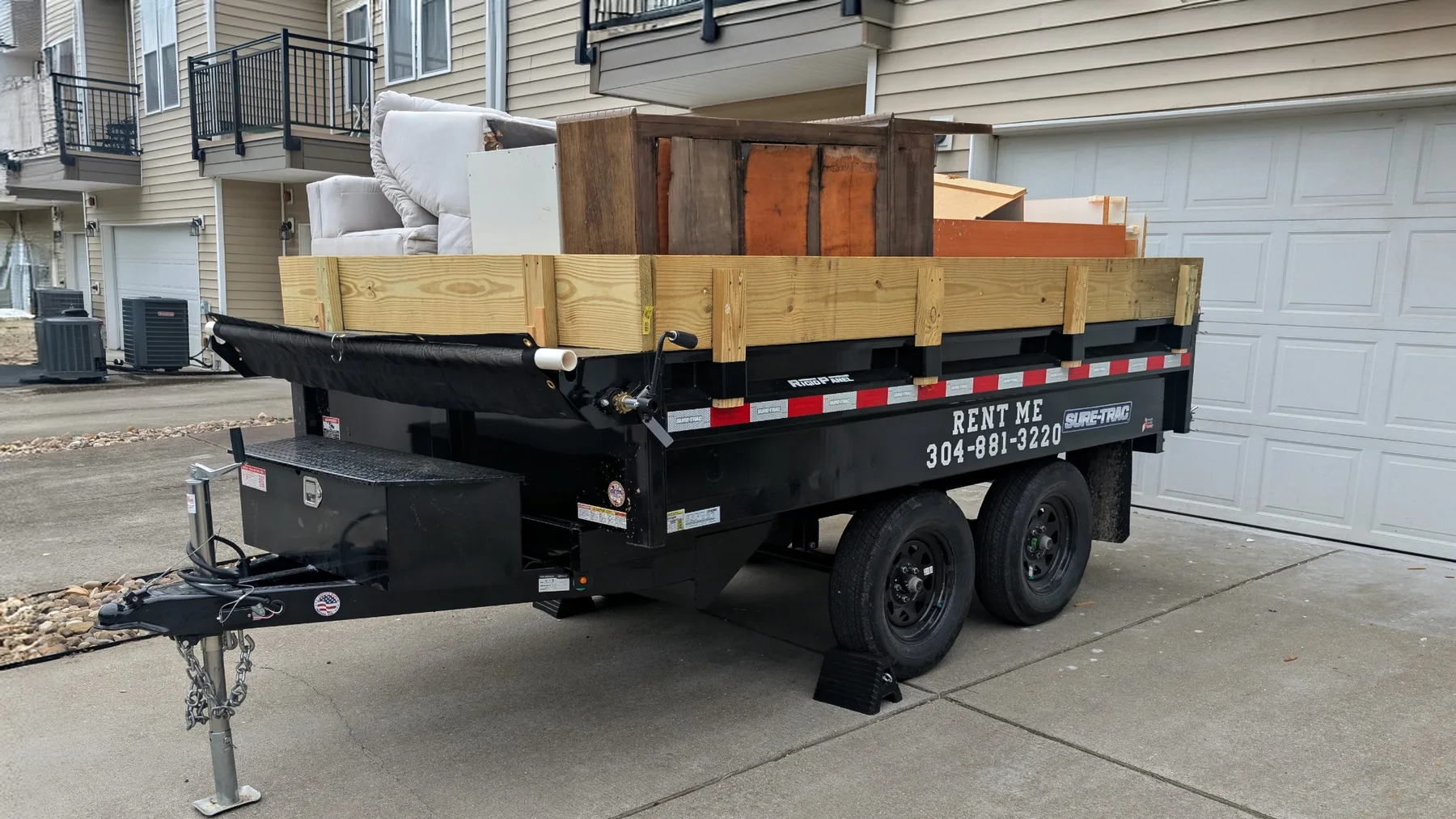 Dump N' Run dump trailer loaded with furniture and household items